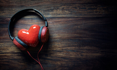 Headphones and red heart concept for love listening to music background - obrazy, fototapety, plakaty