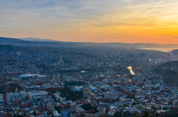 Fototapeta na wymiar Tbilisi at sunrise panoramic view from Mtatsminda Mountain