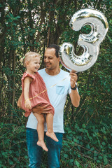Proud dad with his 3 years old daughter outside in the park