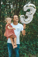 Happy father with his birthday girl outside