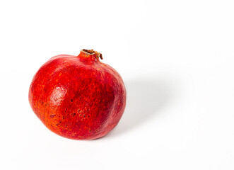 Ripe red pomegranate isolated on white background. Side view.