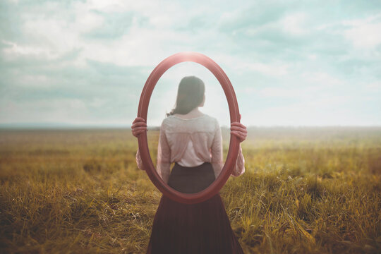 woman holding a mirror who is mirrored appears from behind, identity concept