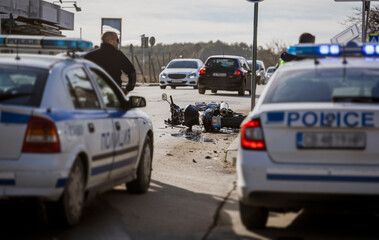 motorcyclist road accident. A motorcycle wrecked in an accident lies on the road