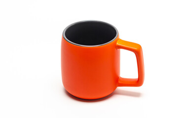 Large orange ceramic mug isolated on white background. Dark middle. Copy space.