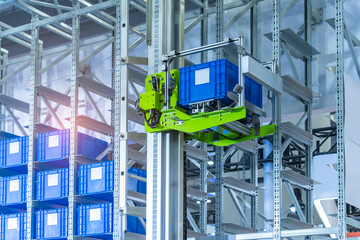 plastic boxes in the cells of the automated warehouse. Metal construction warehouse shelving