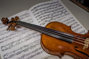 Fototapeta na wymiar Beautiful violin and note sheets on table, closeup