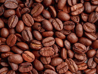 Antique vintage retro bronze coffee mill on black wooden board with roasted coffee beans