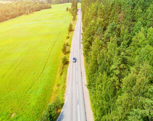 Aerial view of highway with car. Aerial view of a country road with moving car. Aerial road....