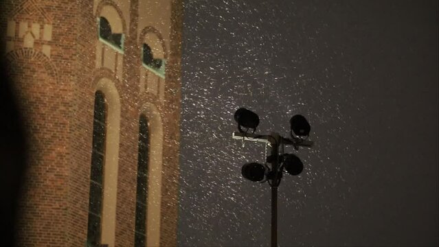 Stockholm, Sweden Snow falls around powerful flood lights illuminating the facade of the Engelbrekt Church in the Ostermalm district. 