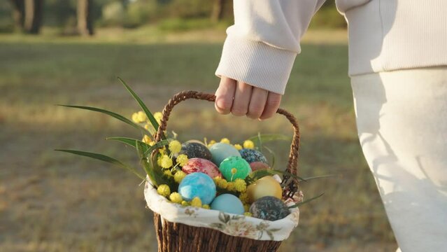 Following a woman in white with a basket of Easter eggs in her hand, a walk through the forest on a sunny morning.