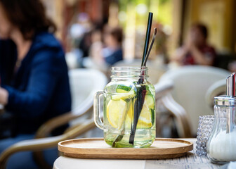 Glass of lemon and cucumber  lemonade on a table in a café