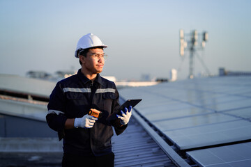 Confident Asian male engineer Get ready to work on inspecting the solar panels. solar power plant...