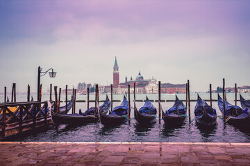 Gondolas in Venice with Abbey of San Giorgio Maggiore in the background. Ferry Gondola Pier. Venice, Italy - obrazy, fototapety, plakaty