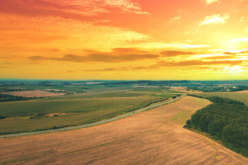 View of the arable field during sunset. Rural landscape