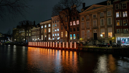 Fototapeta na wymiar Amsterdam, the Netherlands - December 18, 2023: In December and January, the city-center lights up during free Amsterdam Light Festival.