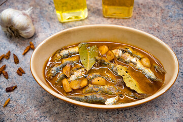 Sardinas en escabeche (pickled sardines); Bowl of sardines in a tasty balsamic sauce as well as garlic, chili and bay leaf.