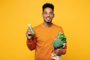 Young man wear casual clothes hold show juice green vegetable smoothie as detox diet, greenery...