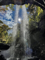 Sun shining through a waterfall Falls of Hills Creek