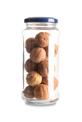Whole dried limes, in a glass jar with lid. Loomi, black lime, noomi basra, or also limoo amani, strongly flavored, sun-dried fruits, used in the Middle Eastern as sour spice or for dried lime tea.