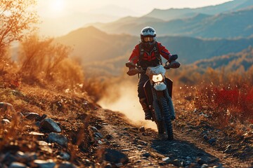A male expert motorcyclist wearing complete motorcycle gear riding a dirt bike on a mountain road during sunset