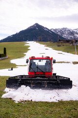 A snow groomer (snow cat, piste machine or trail groomer) waiting to be used to prepare the ski...