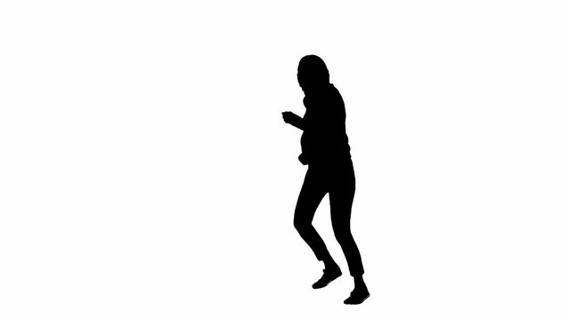 Black silhouette of a woman on a white isolated background. A young girl runs, fearfully looking around, fleeing faster from danger. Half turn.
