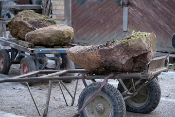 large boulders on carts in stone workshop