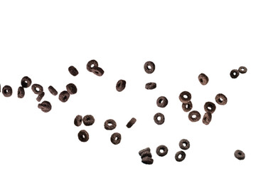 Chocolate rings cereal spill out into a bowl. Breakfast.