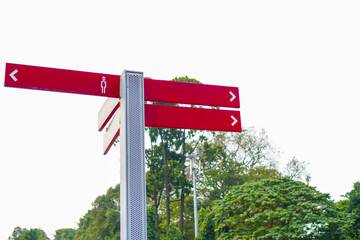 Directional sign post template set against a scenic backdrop of green trees and a dreamy cloudy sky
