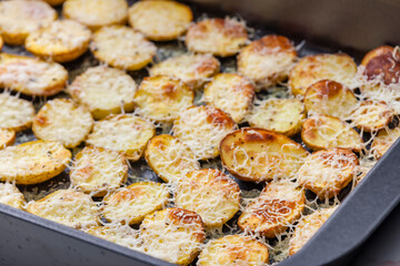 slices of potatoes baked with grated cheese