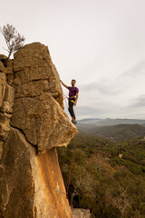 Person climbing in high mountains with yellow jacket rope and helmet in nature, confidence and...