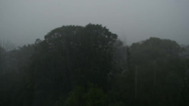 Closeup of rain falling against a window during a heavy rainstorm