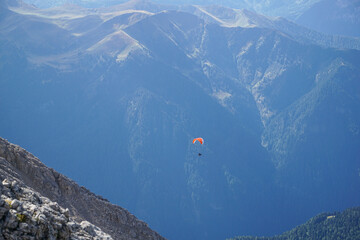 Paragliding in the dolomite mountains: flying in incredible panoramic mountain scenery in South...