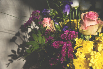 Colorful bouquet and its shadow. Floral arrangement background. Dreamy haze effect. 