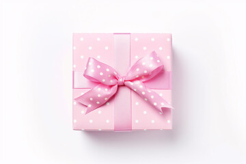 Top view of pink gift box with ribbon and white dots on white background