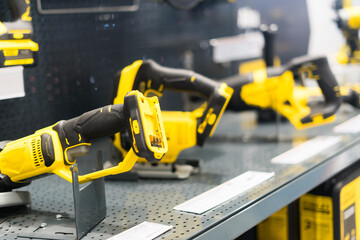 Power tools, drills and hammers of various manufacturers are sold in a hardware store.