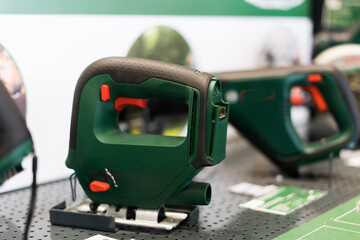 Power tools, drills and hammers of various manufacturers are sold in a hardware store.