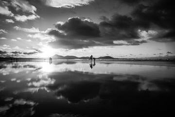 The evening's Famara Beach (Playa de Famara) -  popular surfing beach in Lanzarote. Canary Islands. Spain. Black and white.