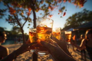 Poster Hands hold glasses of beer against tropical sea beach. Friends drinking alcohol at open air party during summer holiday. People toasting with beer © Lazy_Bear