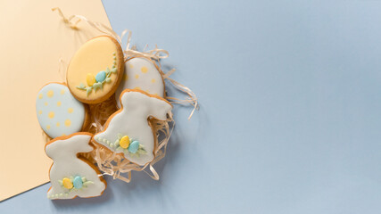 Four beautiful tasty delicious glazed Easter cookies in the shape of an egg and bunnies on the...