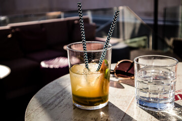 Cold drinks on wooden table in cafe. Tonic, mojito cocktail, spritz, water in drinking glass on...