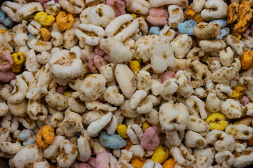 Pufarine is a colored sweetened expanded wheat loved by children.  Macro photo of pufarin