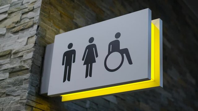 Information stand at the entrance to the toilet with a classifier of the gender of citizens and disabled people, close-up