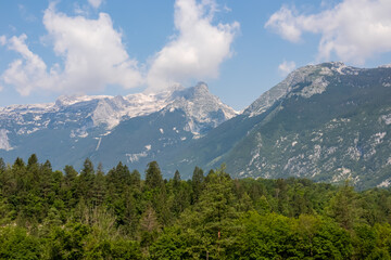 Fototapeta na wymiar Panoramic view of mount Vrh Jerebceve police and Monte Forato seen from Bovec, Julian Alps, Slovenia Jagged contours of majestic mountain peaks in Soca valley. Wanderlust hiking in wild Slovenian Alps