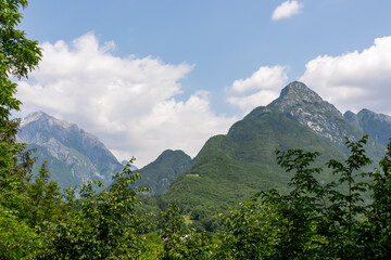 Scenic view of mount Svinjak and Krnice seen from Bovec in Julian Alps, Slovenia. Jagged contours of majestic mountain peaks in serene Soca valley. Wanderlust in untamed Slovenian Alps. Hiking - obrazy, fototapety, plakaty
