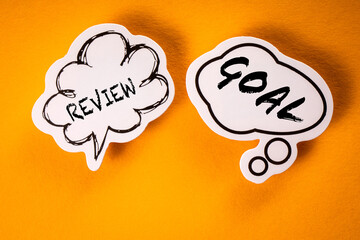 Review and Goal Concept. Speech bubbles on a yellow background