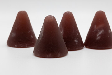 Closeup of cuberdon, a cone-shaped Belgian candy on a white background
