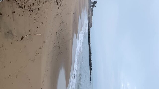 Waves in the ocean, panoramic view of sandy beach