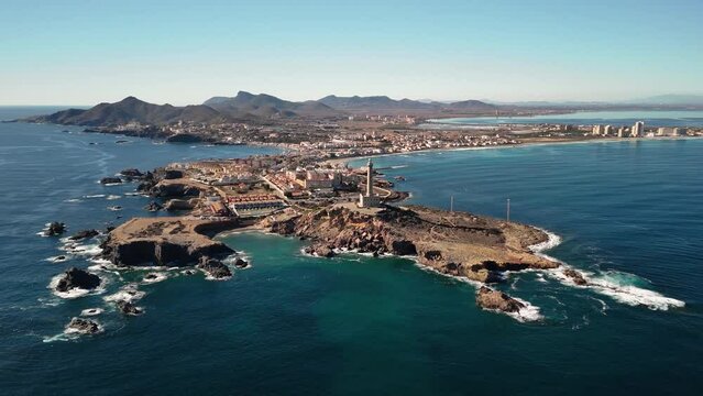 Drone flight over Cabo de Palos and La Manga in Murcia, Spain. Panoramic view of the Mediterranean coast. Sea and blue sky on a sunny day.