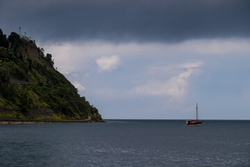 Panoramic view from Fiesa on the coastline of Piran peninsula, Slovenian Istria, Slovenia, Europe. rugged rocky cliffs that majestically overlook the shimmering Adriatic Sea. Boat floating in the bay